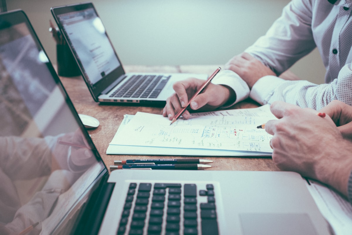Professionals reviewing investment property financing terms and documents