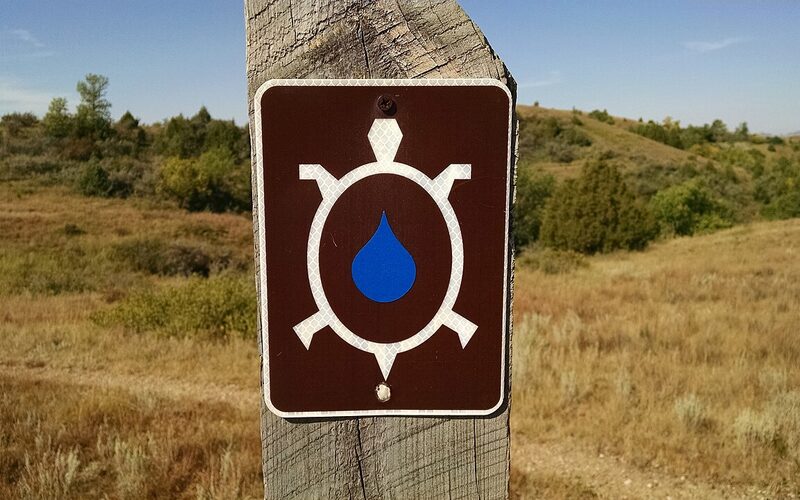 Mountain biker on the Maah Daah Hey Trail winding through North Dakota Badlands terrain